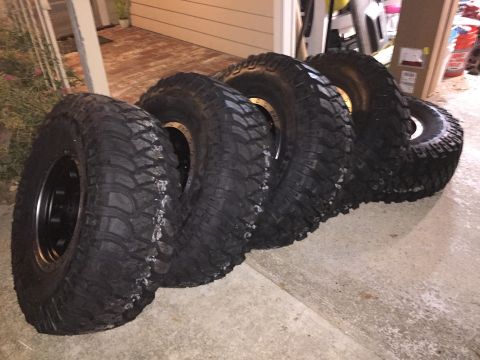1989 Ford Bronco - A set of four off-road tires are displayed, ready for adventure.