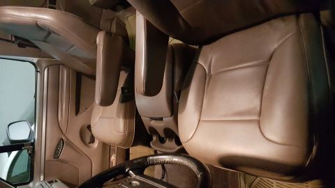1995 Ford Bronco - Interior view of a vehicle's front seats and dashboard area, showing tan leather upholstery.
