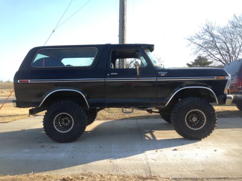 1979 Ford Bronco - This black Ford Bronco is shown from the side, lifted with large off-road tires.