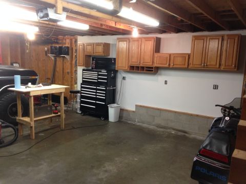 1979 Ford Bronco - Garage scene includes a black pickup truck, a snowmobile, and various tools and storage cabinets.