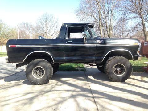 1979 Ford Bronco - This black Ford Bronco, likely a 1978 model, is modified with oversized tires and a lifted suspension.