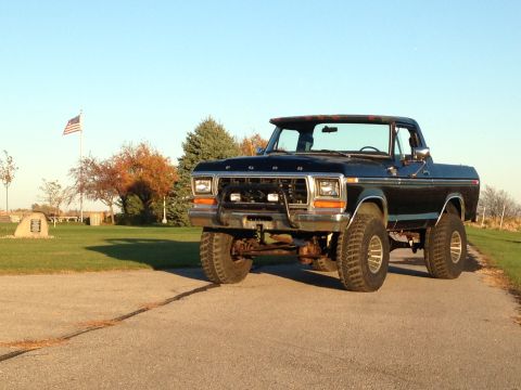 1979 Ford Bronco - A lifted 1979 Ford Bronco is shown from a three-quarter front view on a sunny day.