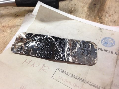1979 Ford Bronco - A VIN plate stamped with "78" is shown on top of vehicle registration documents.
