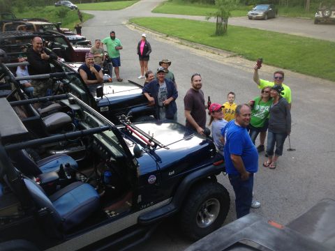 1979 Ford Bronco - People gather around multiple Jeeps during an outdoor event.