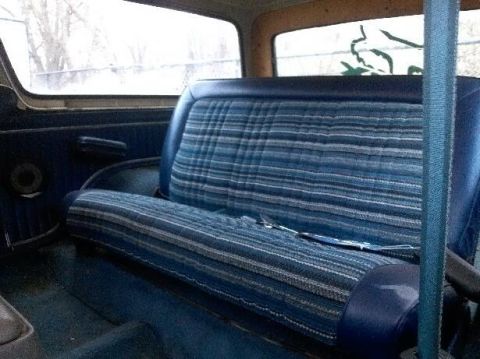 1979 Ford Bronco - The interior features blue plaid upholstery on the seats and matching door panels.