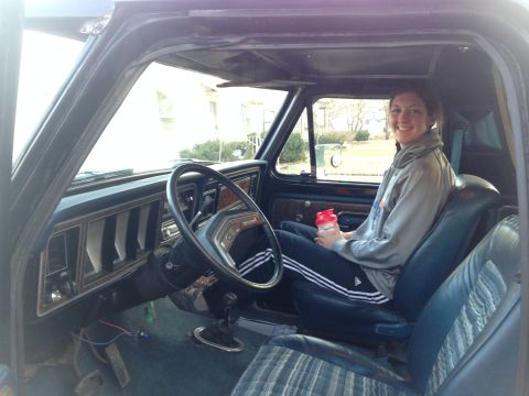 1979 Ford Bronco - Woman sits in the passenger seat of a 1979 Ford Bronco's interior.