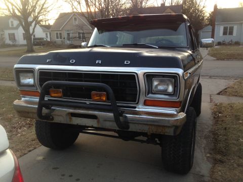 1979 Ford Bronco - This black 1978 Ford Bronco is shown from the front with a chrome grille guard and a sun visor.