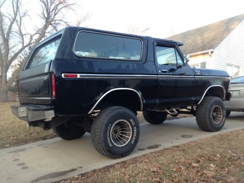 1979 Ford Bronco - This black 1979 Ford Bronco is shown from the rear three-quarter angle on a driveway.