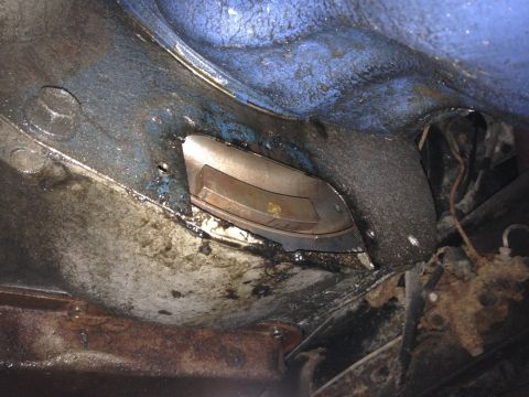 1979 Ford Bronco - Close-up of the vehicle's undercarriage, revealing frame components and accumulated grime.