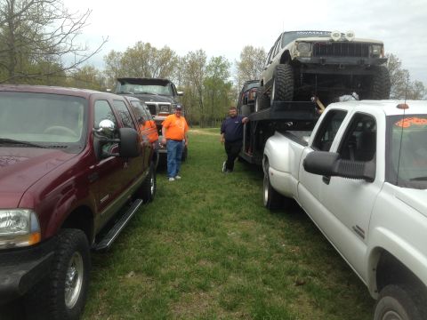 1979 Ford Bronco - A collection of trucks and a Jeep are gathered outdoors on a grassy area.