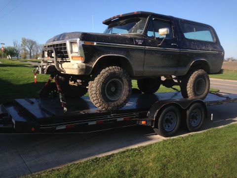 1979 Ford Bronco - This lifted black 1979 Ford Bronco is being transported on a trailer.