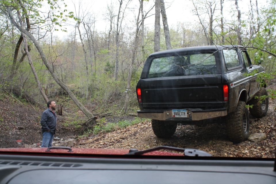 Black 1978 Ford Bronco rear view on a dirt trail