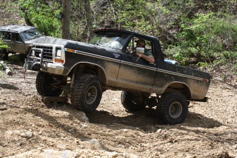 1979 Ford Bronco - This 1979 Ford Bronco navigates a challenging off-road course with another vehicle visible in the background.
