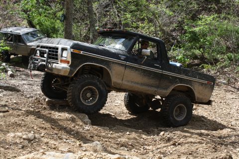 1979 Ford Bronco - Modified 1978 Ford Bronco navigating a challenging off-road course with a second vehicle visible.