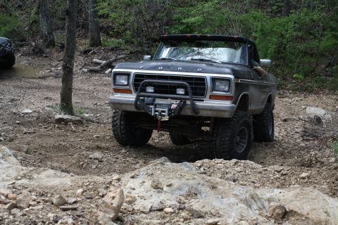 1979 Ford Bronco - This 1979 Ford Bronco is equipped with a winch and is navigating a rocky, wooded trail.