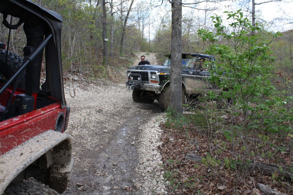 Black 1979 Ford Bronco on a dirt road, front 3/4 view