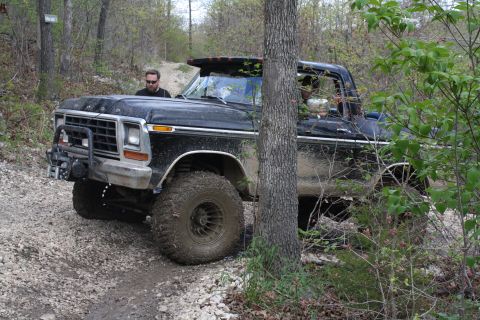1979 Ford Bronco - Off-road adventure in a classic Ford Bronco navigating a wooded trail.