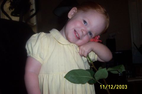 1979 Ford F-150 - A young child smiles while holding a flower stem, with a date stamp visible in the lower right corner.