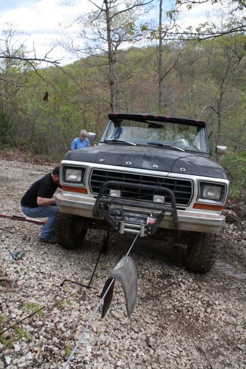 1979 Ford Bronco - A black 1978 Ford Bronco is being worked on by a person in front of it, with another person standing behind it.