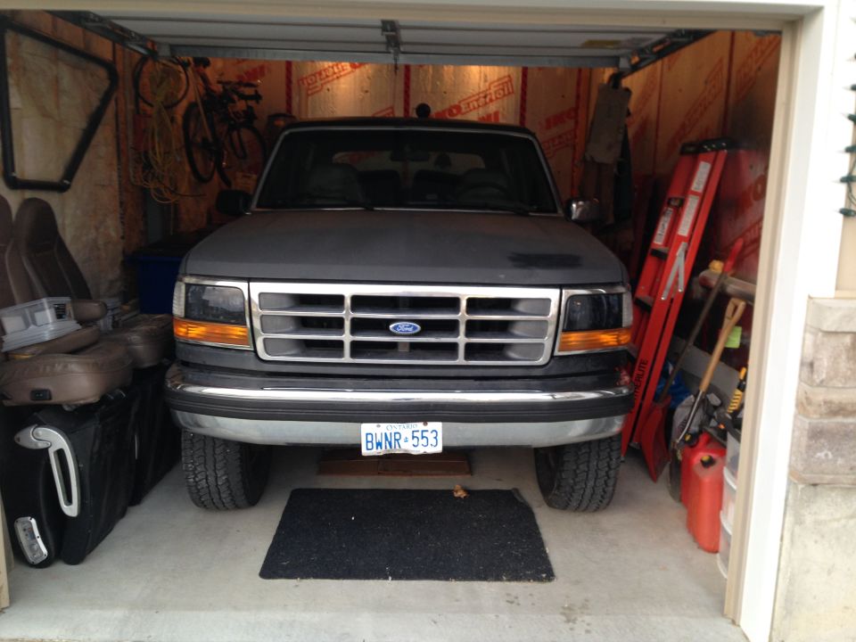 1992 Ford Bronco parked in a garage, front view. License plate BWNR-553