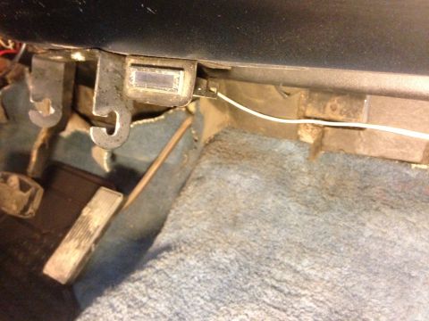 1979 Ford Bronco - Close-up view of a vehicle's interior, focusing on the floor area with pedals and carpeting.