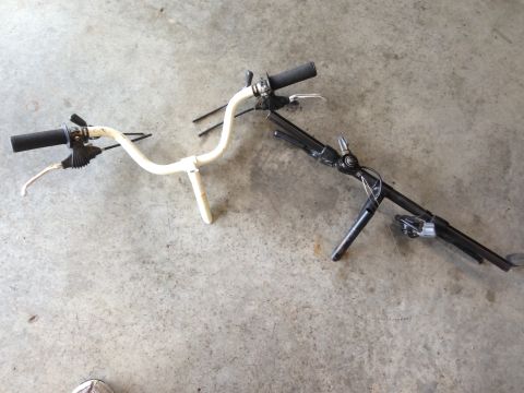 1979 Ford Bronco - Bicycle handlebars and kickstand shown on a concrete surface.
