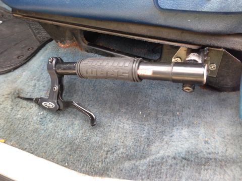 1979 Ford Bronco - A bicycle's brake lever and grip are visible, mounted near the vehicle's seat.