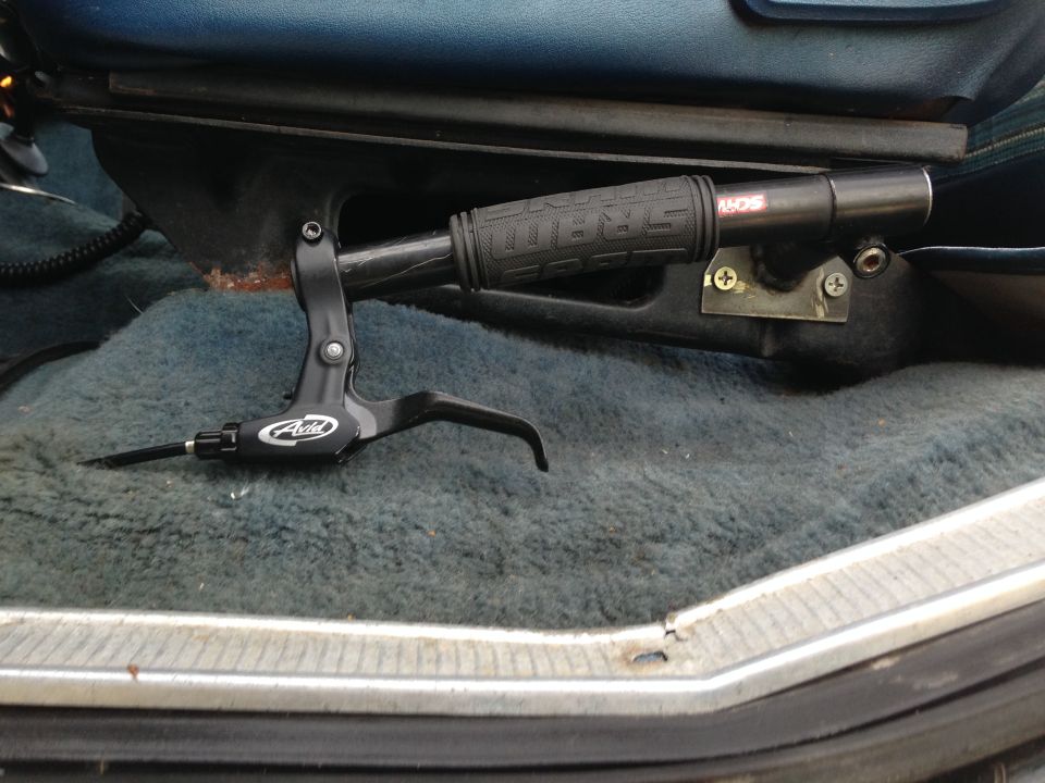 Black Avid handbrake lever and SRAM grip mounted on vehicle floor