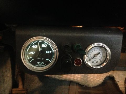 1979 Ford Bronco - Close-up of dashboard gauges and switches, showing oil and air pressure readings.