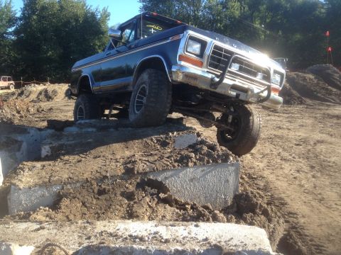 1979 Ford Bronco - This lifted Ford truck navigates a challenging off-road course with concrete blocks.