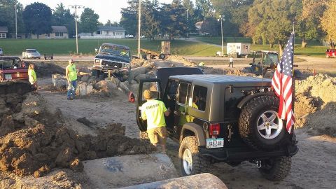 1979 Ford Bronco - A black 1979 Ford Bronco navigates an off-road obstacle course at a Jeep show.
