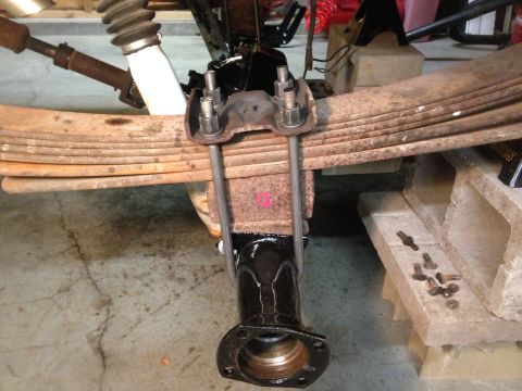 1979 Ford Bronco - Close-up view of a vehicle's rear axle and leaf spring suspension system, likely undergoing maintenance or repair.