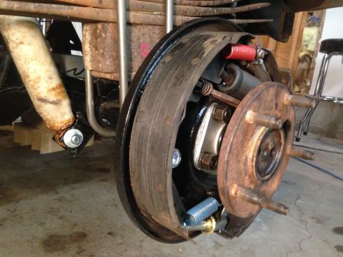 1979 Ford Bronco - This photo shows a close-up view of a vehicle's rear drum brake assembly, including the brake shoes and springs.