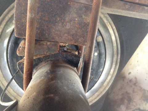 1979 Ford Bronco - Underside view of vehicle's rear axle and suspension system, showing signs of rust and wear.