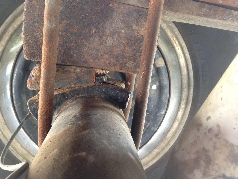 close-up of rusty suspension parts and tire rim