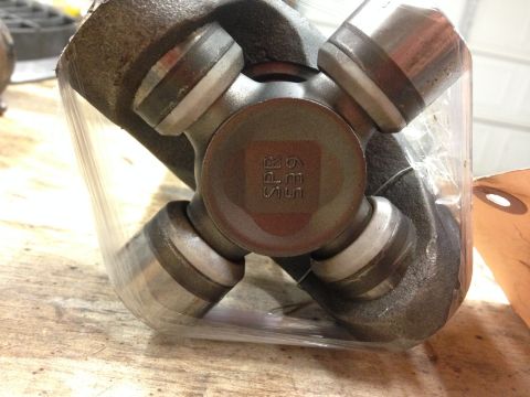 1979 Ford Bronco - Close-up of a universal joint, "SPR 65E" stamped on its central cap.
