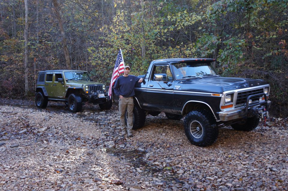 Black 1979 Ford F-150 pickup truck with a winch on the front bumper, parked on a gravel road