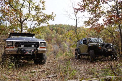 1979 Ford Bronco - A 1979 Ford Bronco is parked off-road in a wooded area during the fall.