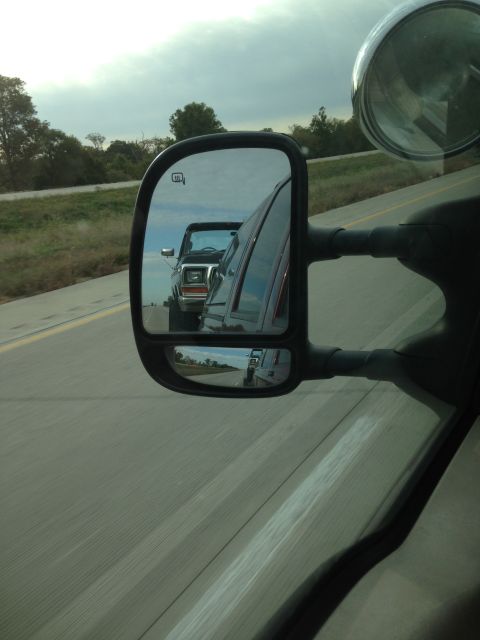 1979 Ford Bronco - A 1978 Ford Bronco is seen in the side mirror while driving on the highway, with another vehicle following behind.