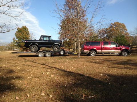 1979 Ford Bronco - A black 1978 Ford Bronco is loaded onto a trailer and towed by a red Ford F-250 Super Duty.