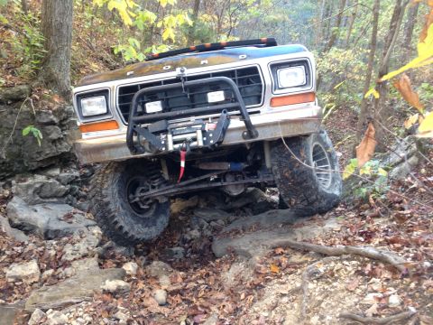 1979 Ford Bronco - A Ford Bronco navigates a challenging rocky trail during autumn.
