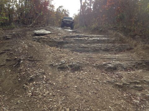 1979 Ford Bronco - A Jeep Wrangler navigates a challenging rocky trail during an autumn off-road excursion.