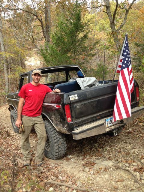 1979 Ford Bronco - Man poses with his 1979 Ford Bronco, which is equipped with an American flag on the rear.