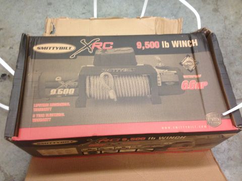 1979 Ford Bronco - The image shows a cardboard box for a Smittybilt XRC 9,500 lb winch. The box displays the product name, specifications like "WATERPROOF 6.6…