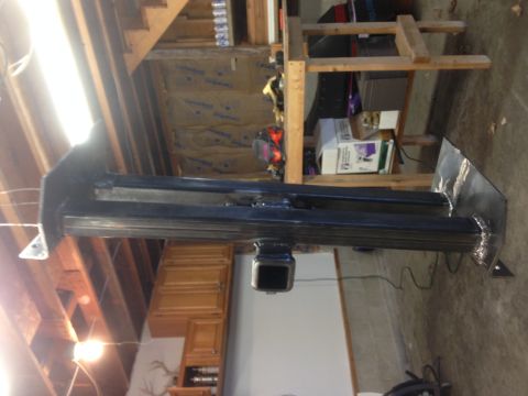 1979 Ford Bronco - A black metal trailer hitch receiver assembly is shown mounted to a flat metal plate, likely in a garage or workshop setting. The assembly…
