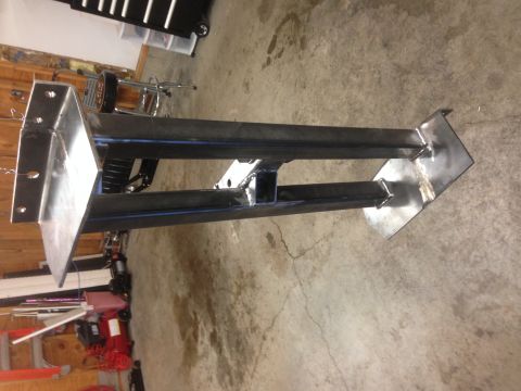 1979 Ford Bronco - This image shows a fabricated metal frame, likely a component for a custom project, resting on a concrete floor. The frame consists of weld…