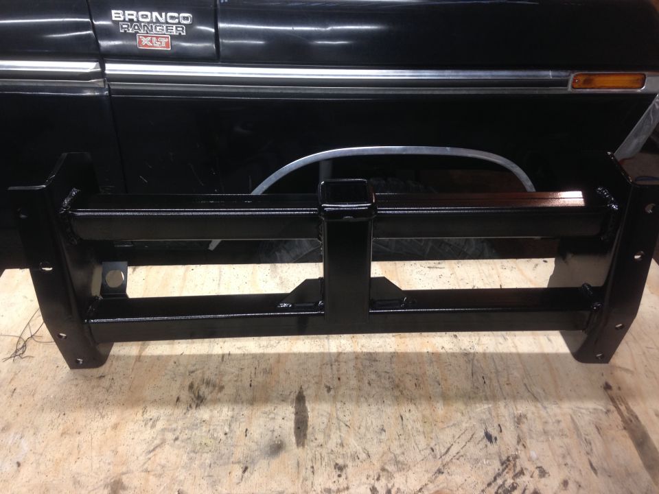 Black custom front bumper in front of a black Ford Bronco