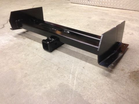 1979 Ford Bronco - A black, rectangular trailer hitch receiver is shown mounted on a concrete floor. The hitch has two mounting plates on either end and a squ…