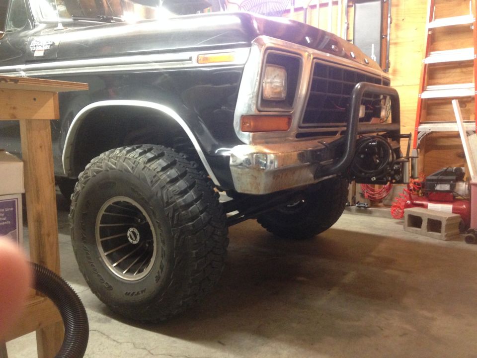 Black 1979 Ford Bronco front quarter view, showing winch mount and large tires