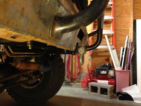 1979 Ford Bronco - Undercarriage view of a vehicle's frame and tire, with a tow hitch visible.